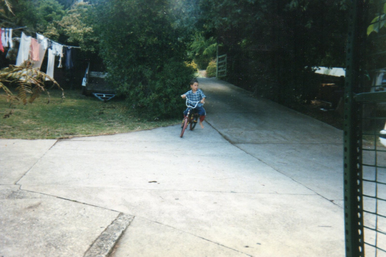 21 Dale Wright riding bike down driveway at Wright